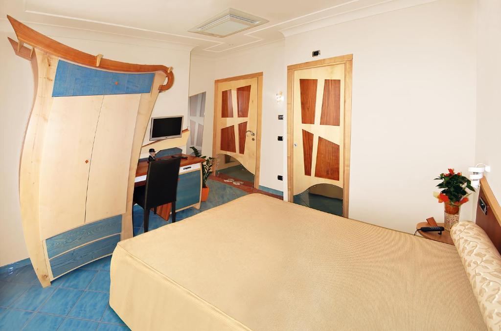 a bedroom with a bed and a desk in a room at Il Principe Resort in Agerola
