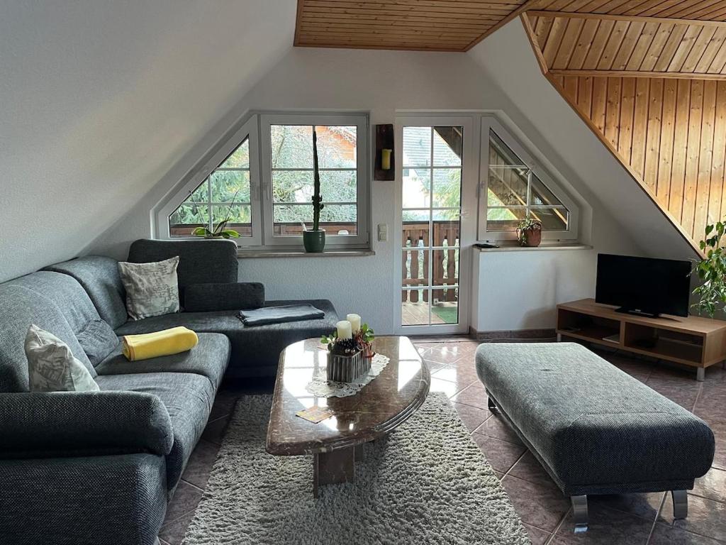 un salon avec un canapé et une table dans l'établissement Ferienwohnung Ruppbergblick, à Zella-Mehlis