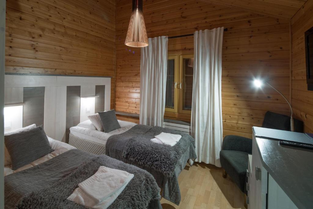 Postel nebo postele na pokoji v ubytování Hotel Ylläshumina