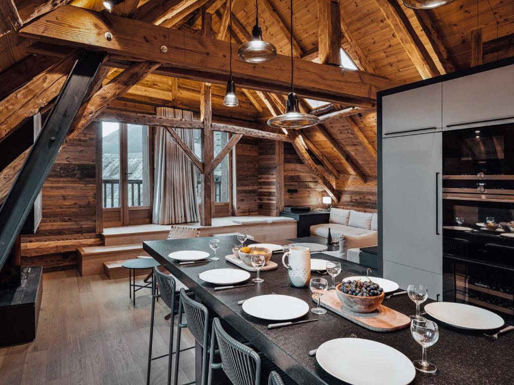 a dining room with a large table and chairs at Duplex moderne au Casset pour 8 pers avec cheminée et balcon - FR-1-808-10 in Le Monêtier-les-Bains