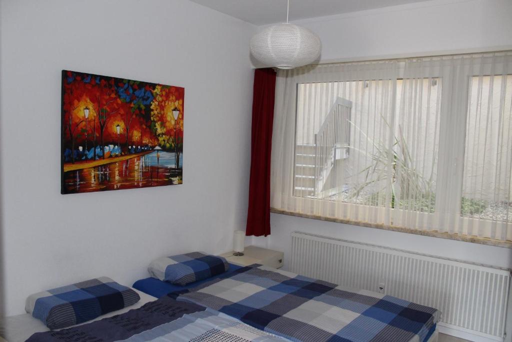 a bedroom with a bed and a painting on the wall at Ferienwohnung C04 in Orselina