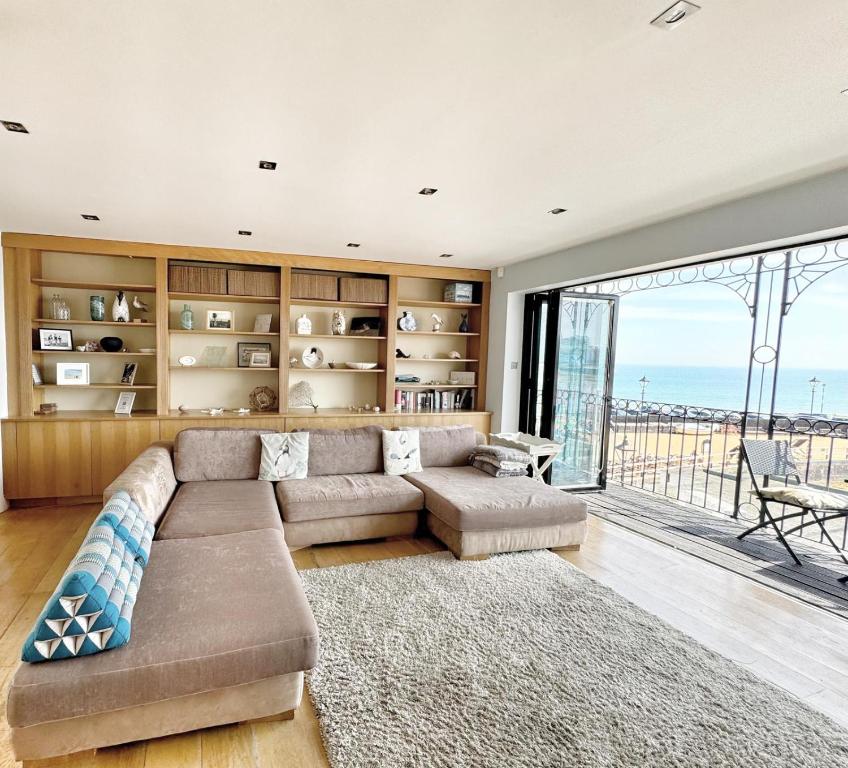 a living room with a couch and a large window at Ancient Lights -Broadstairs Pier in Kent