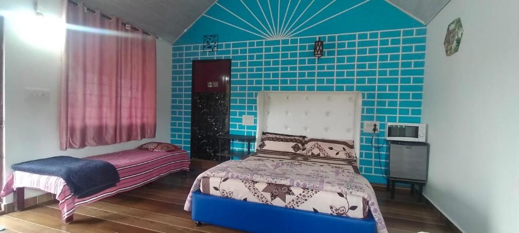 a bedroom with a bed and a blue tiled wall at Marigold Homestay in coorg in Madikeri