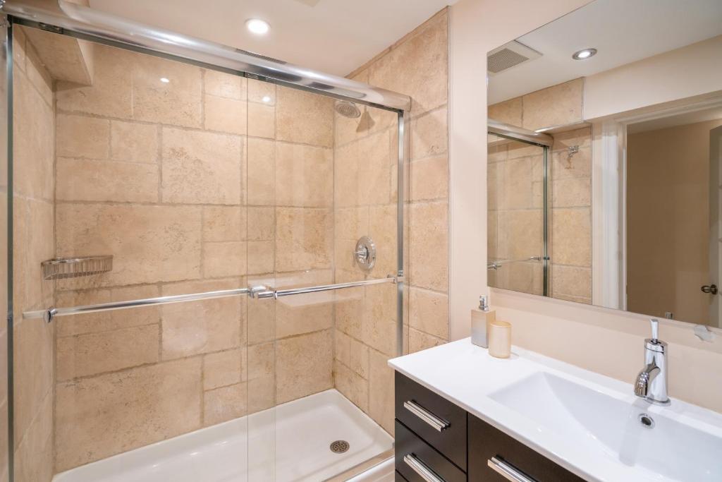 a bathroom with a shower and a sink at Lion's Head B&B in Niagara Falls