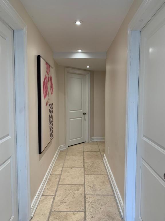 a hallway with a door and a tile floor at Lion's Head B&B in Niagara Falls
