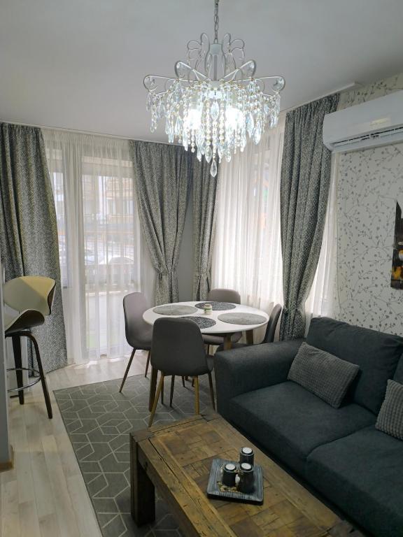 a living room with a blue couch and a table at Snowflake Family, Parking, SPA option, 600mbps in Bansko
