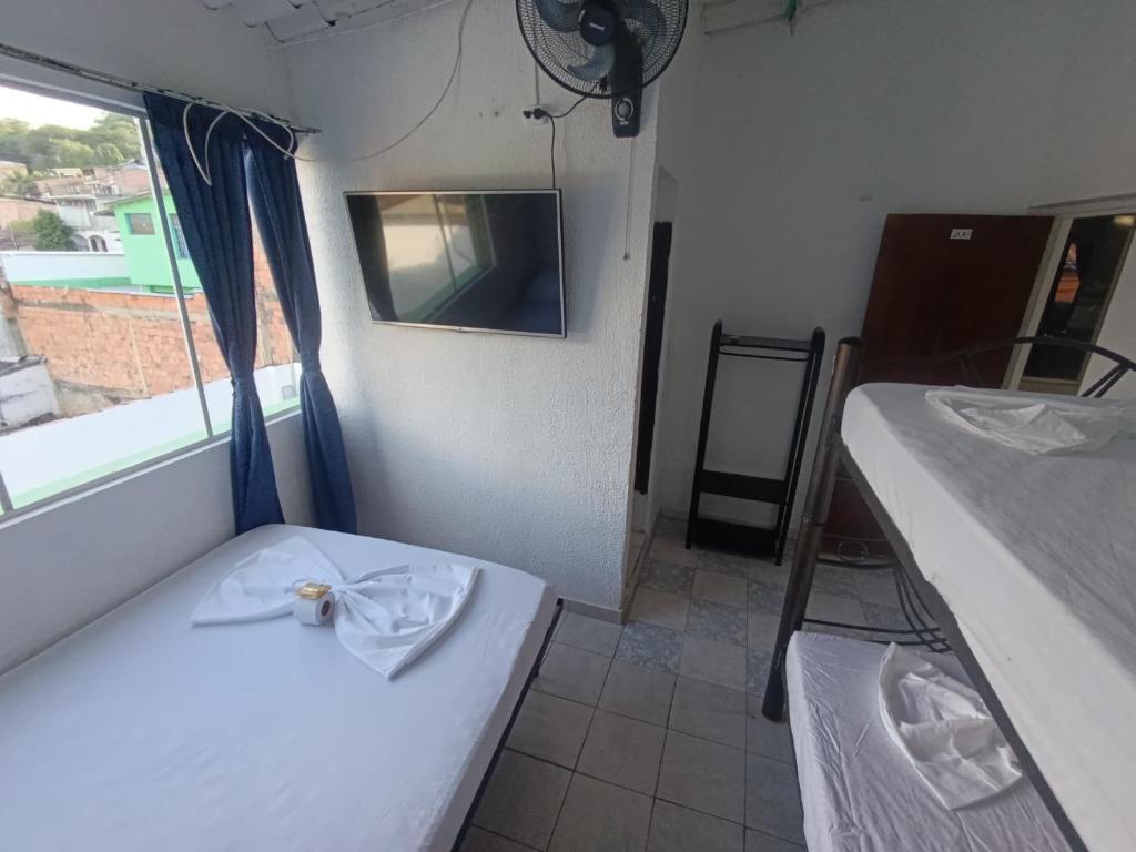 Postel nebo postele na pokoji v ubytování Hotel Mariu Melgar