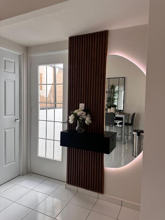 a living room with a door and a mirror at Elegant Modern Tiny Home in San Miguel
