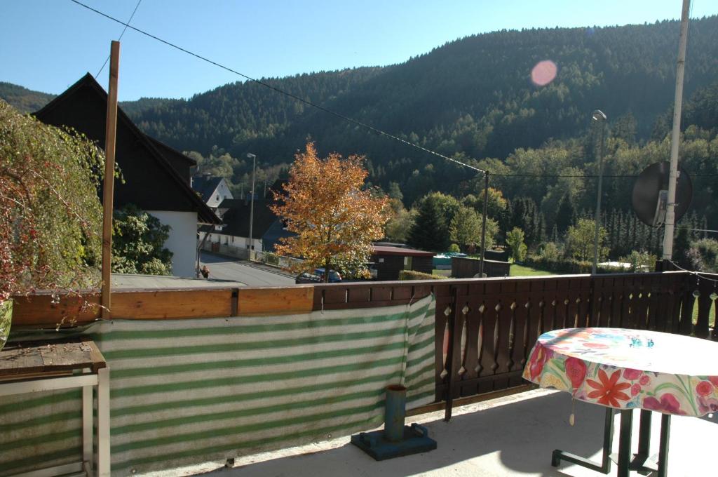 a balcony with a table and a view of a mountain at Gasthof Holländer Eck in Lennestadt