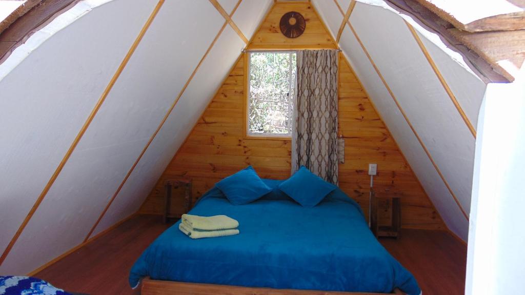 Postel nebo postele na pokoji v ubytování Glamping Eluney Bucalemu