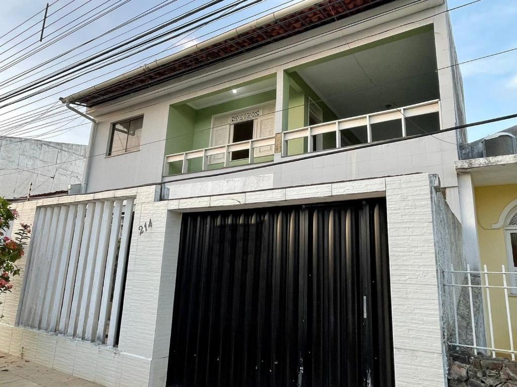 a house with a large window and a garage at Green House in Aracaju