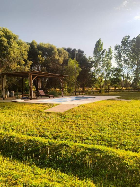 a park with a picnic shelter in a field at Cabañas El Rosedal in San Rafael