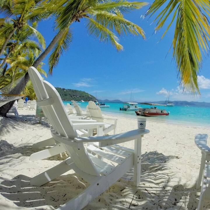 a group of lawn chairs sitting on a beach at St Thomas Luxury Beach Resort in Nazareth