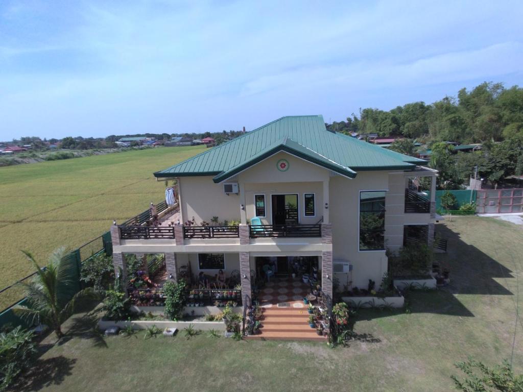 an aerial view of a house with a green roof at Elenem Resort in Magalang