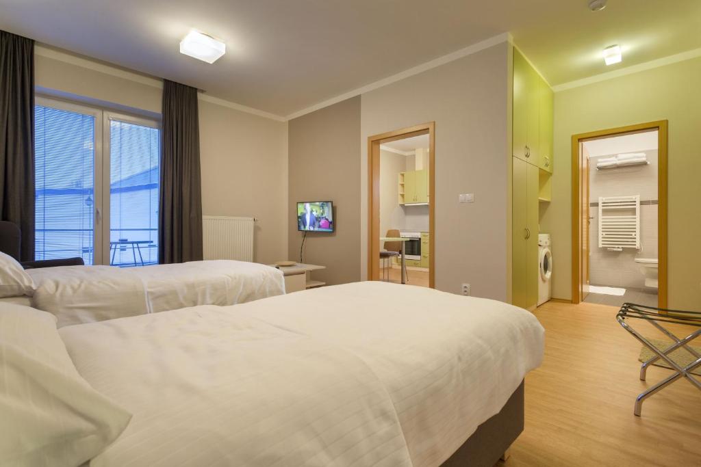 Postel nebo postele na pokoji v ubytování Apartmány Abacie