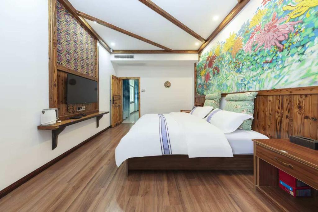 Postel nebo postele na pokoji v ubytování Hotel California Zhangjiajie