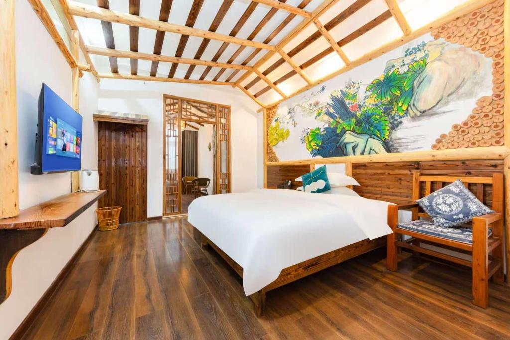 Postel nebo postele na pokoji v ubytování Hotel California Zhangjiajie