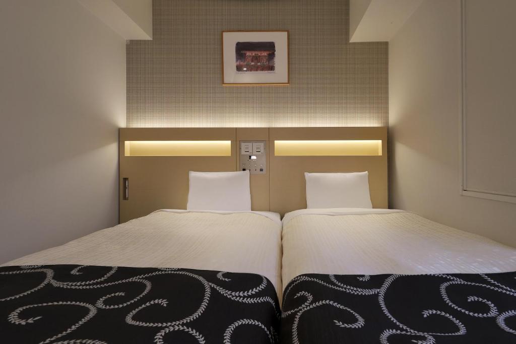 Postel nebo postele na pokoji v ubytování Keio Presso Inn Nihonbashi Kayabacho