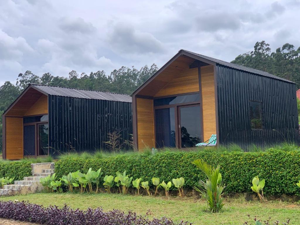 a house with a row of plants in front of it at Vila Kopi Ciwidey in Ciwidey