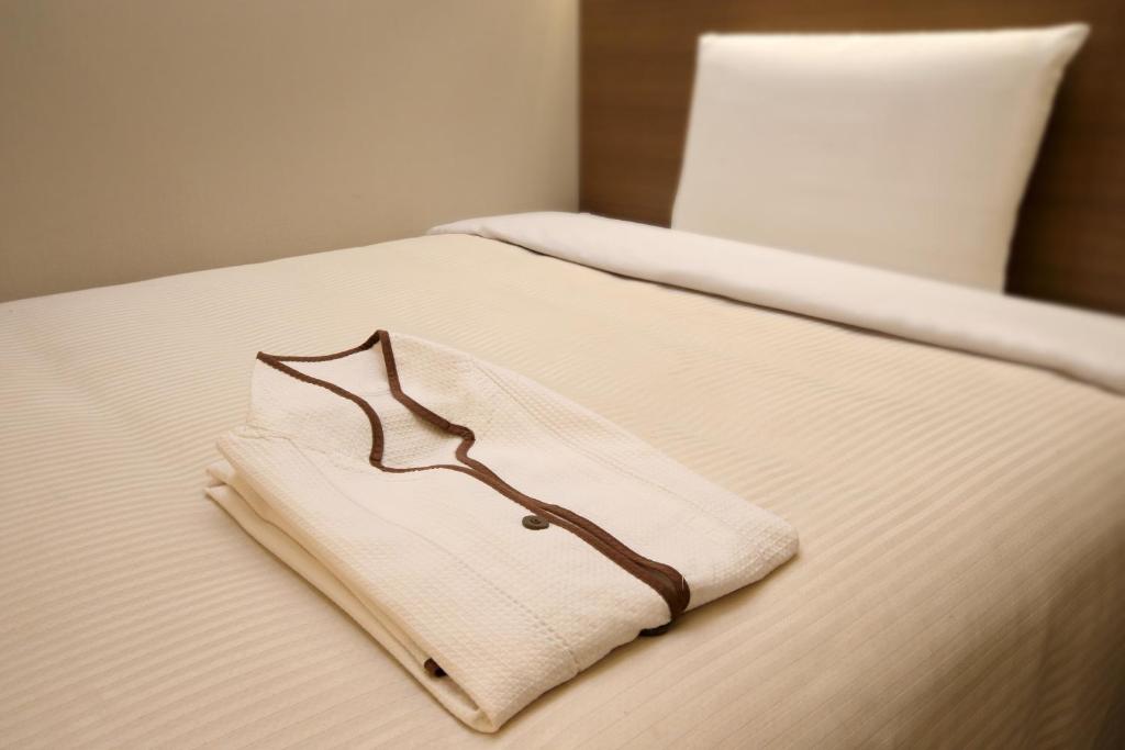 Postel nebo postele na pokoji v ubytování Keio Presso Inn Nihonbashi Kayabacho
