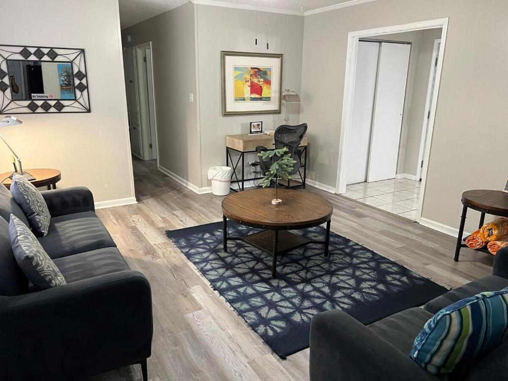a living room with a couch and a table at Sweet Home Alabama 4BR 2BA oasis with pool WI-FI in Montgomery