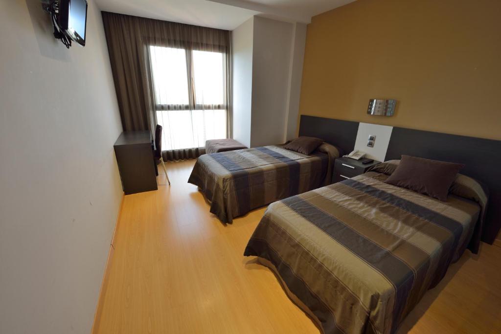 Posteľ alebo postele v izbe v ubytovaní Hotel Ciutat d'Amposta