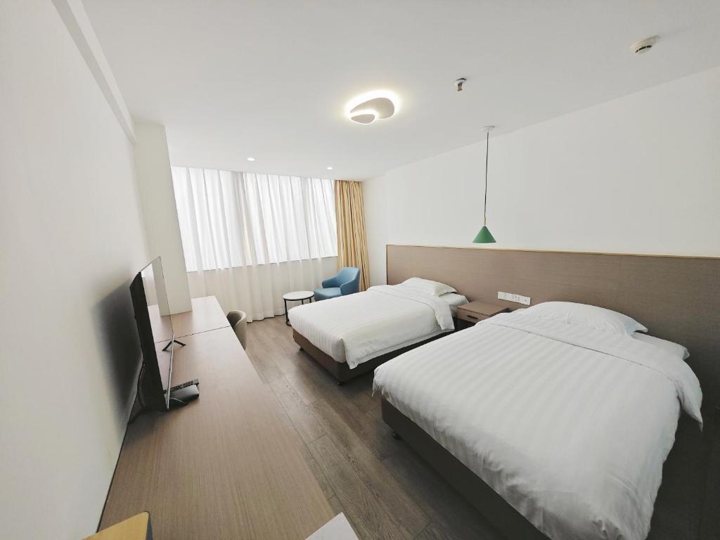 Postel nebo postele na pokoji v ubytování Shenzhen Xinghua Hotel
