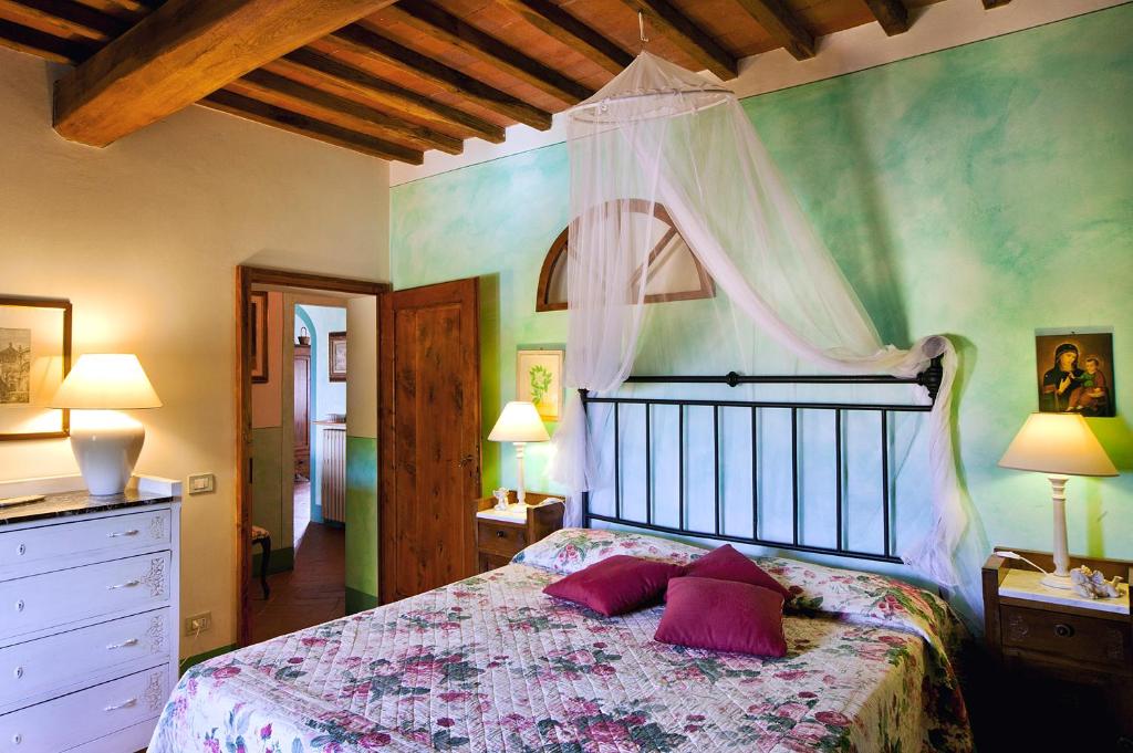 een slaapkamer met een bed met paarse kussens erop bij Borgo dei Cadolingi in Gambassi Terme