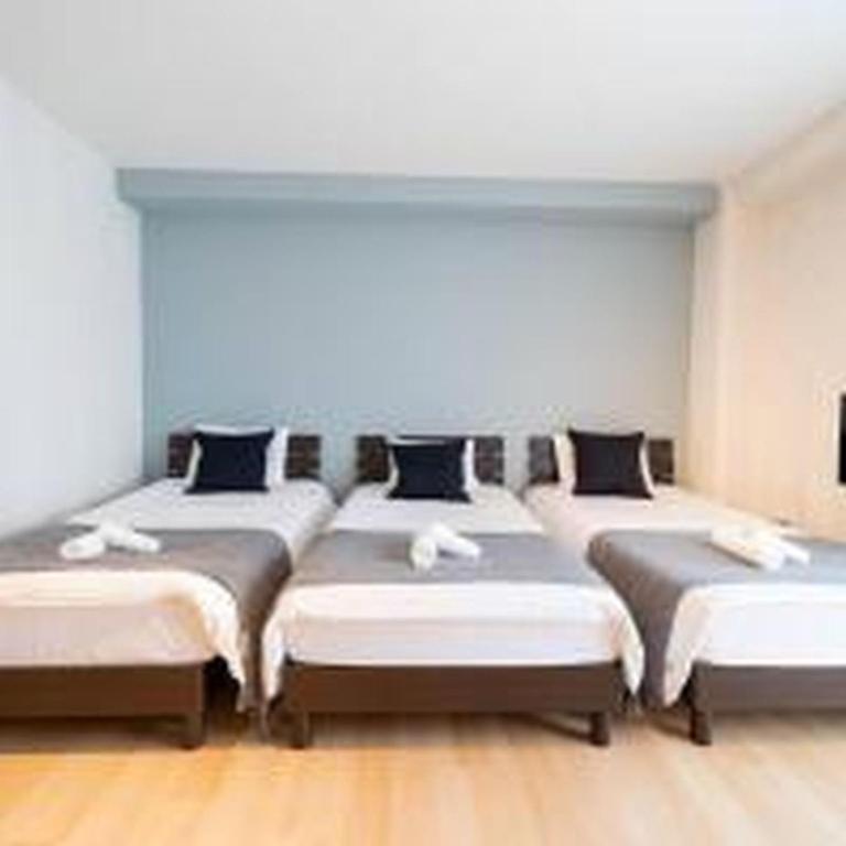 a room with four beds in a row at Mutsumi Konohana 601 むつみ庵此花 601 in Osaka