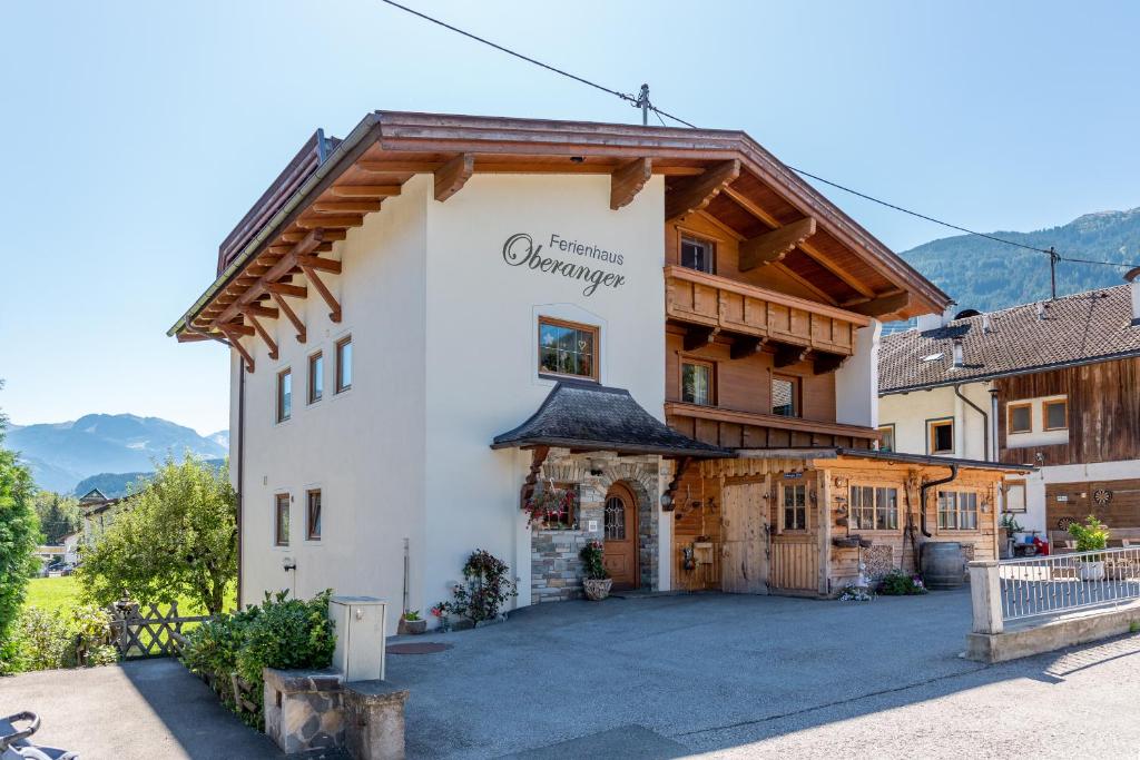 a large white building with a sign on it at Ferienhaus Oberanger in Kaltenbach