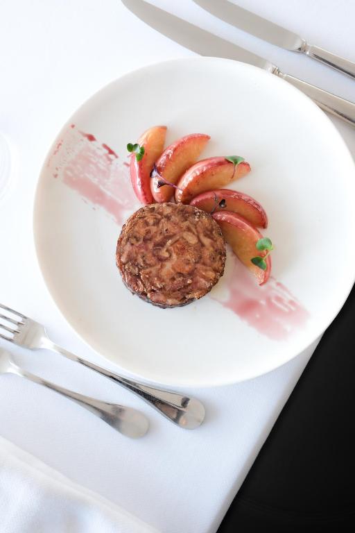 a plate of food with a cookie and apples on it at Thalazur Ouistreham - Hôtel & Spa in Ouistreham