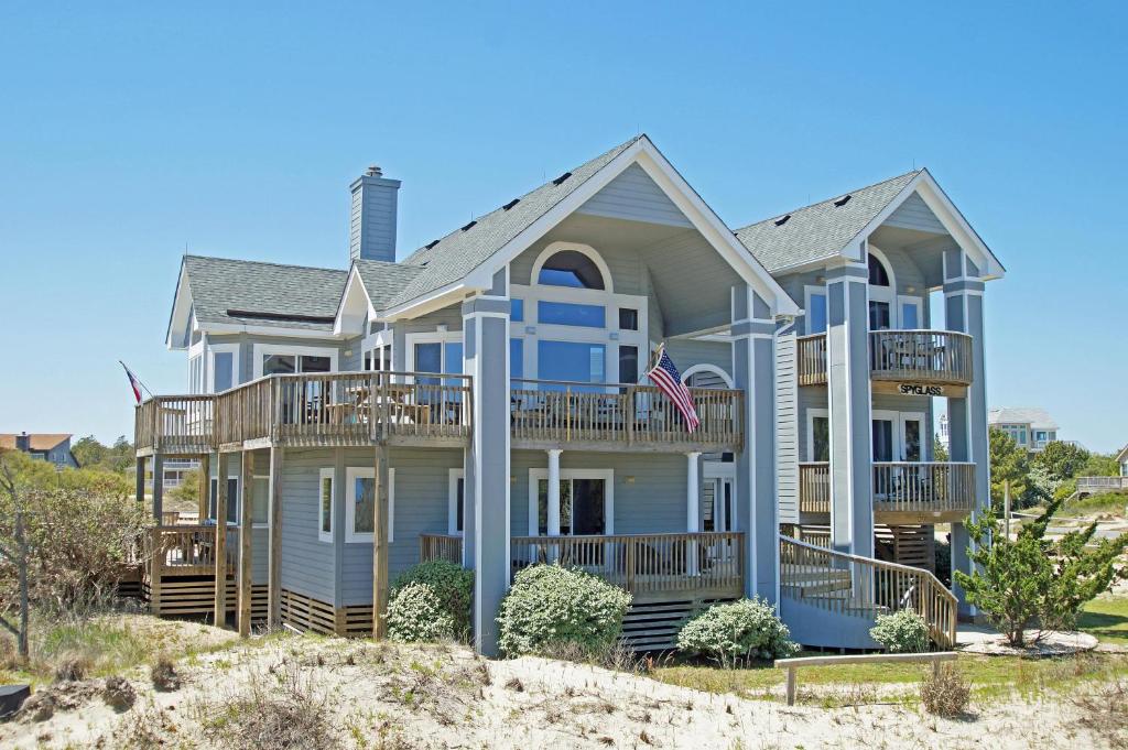 a house on the beach with an american flag at OH1200-Spyglass in Corolla