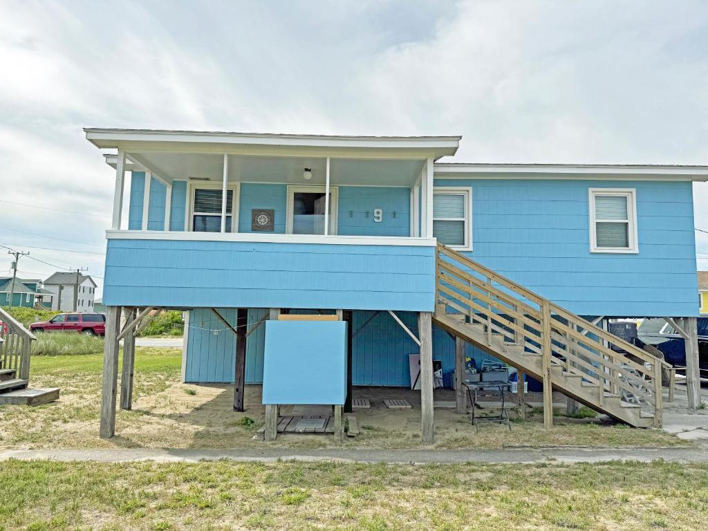a blue house with a porch and a deck at KH4300- Weather Station in Kitty Hawk