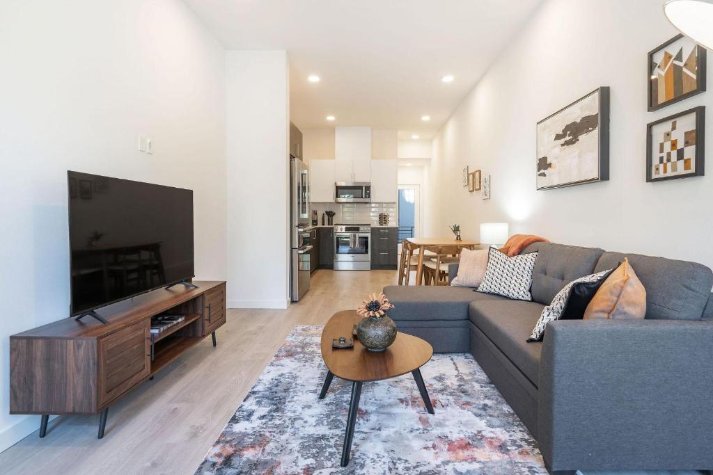 a living room with a couch and a tv at Perch - Urban Reflection 13 in Seattle