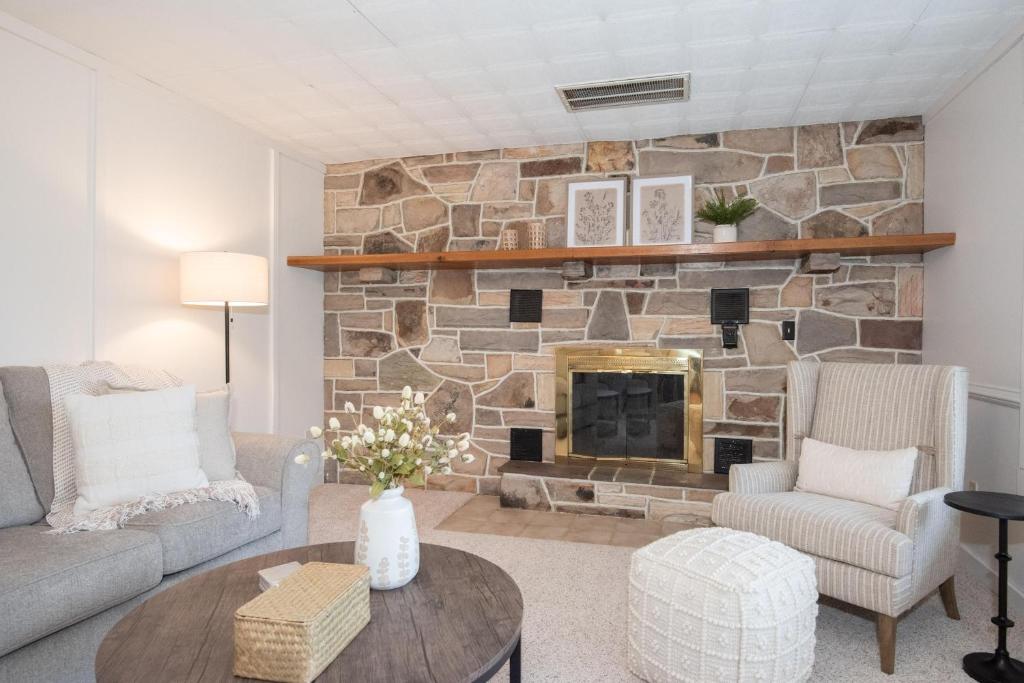 a living room with a stone fireplace at Inglewood Cottage in Saint Thomas
