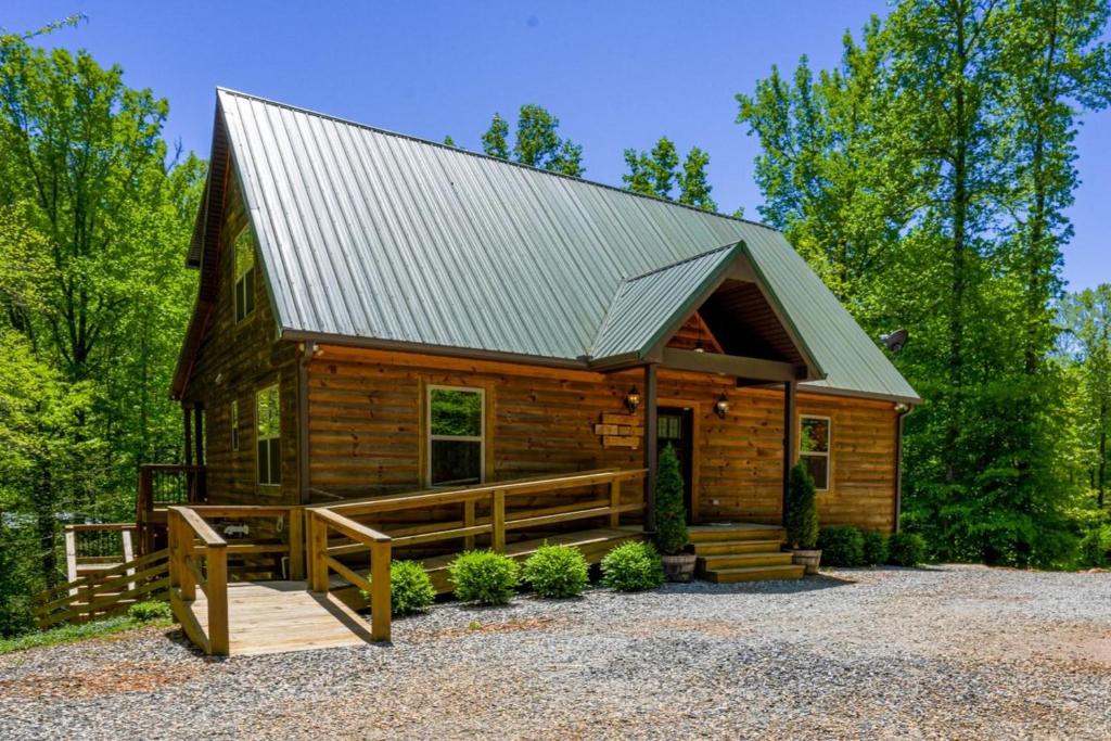 a log cabin with a metal roof at New Listing! Wine Country Retreat - 2 Bed, Hot Tub in Dahlonega