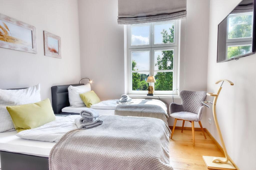 Postel nebo postele na pokoji v ubytování Ferienwohnung Kleine Auszeit in Putbus