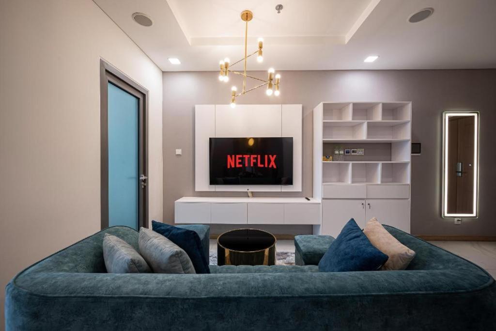 a living room with a blue couch and a tv at Old Bui in Ho Chi Minh City