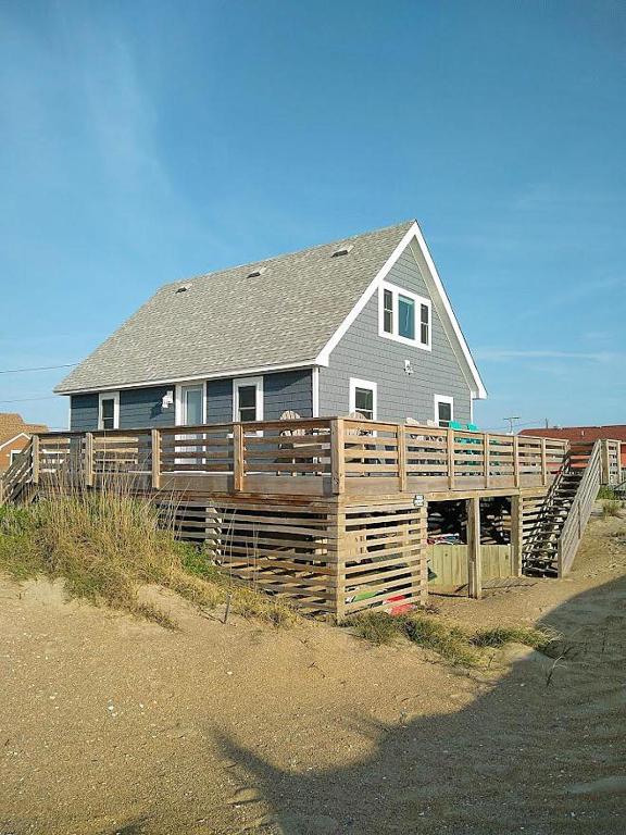 a house with a wooden fence in front of it at KH4117- Beach Balm in Kitty Hawk