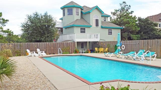 a swimming pool in front of a house at WH1020- Crab Quarters in Corolla