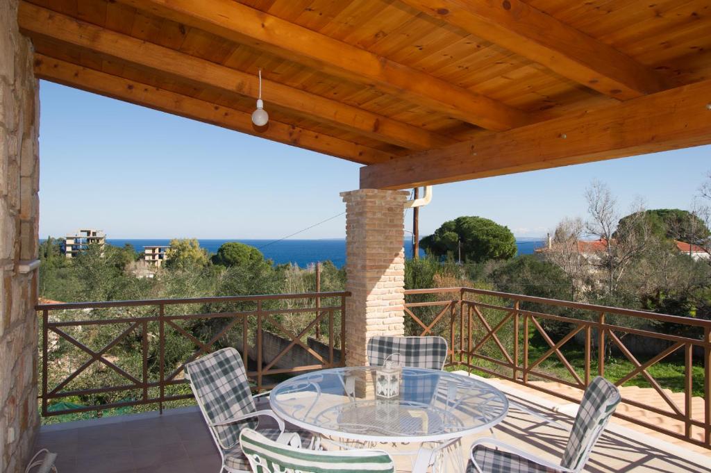 a patio with a table and chairs on a balcony at Fioro Stone House in Tsilivi