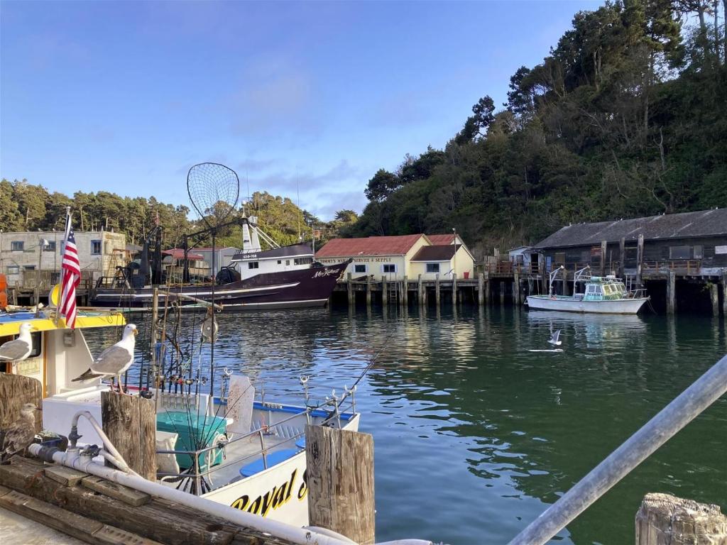a boat is docked at a dock in the water at Poop Deck in Fort Bragg