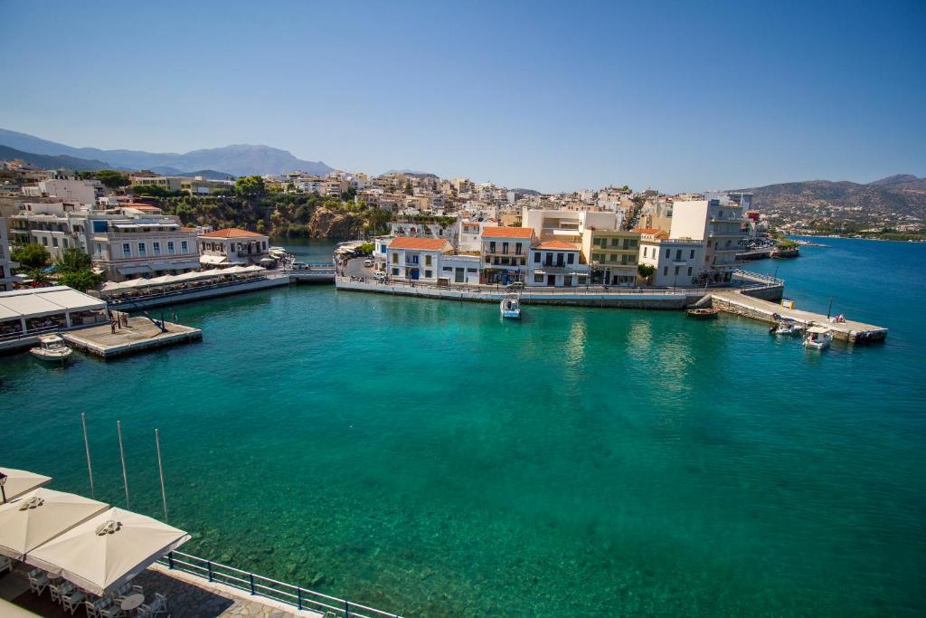 an aerial view of a body of water with buildings at Porto Maltese Boutique Estate in Agios Nikolaos