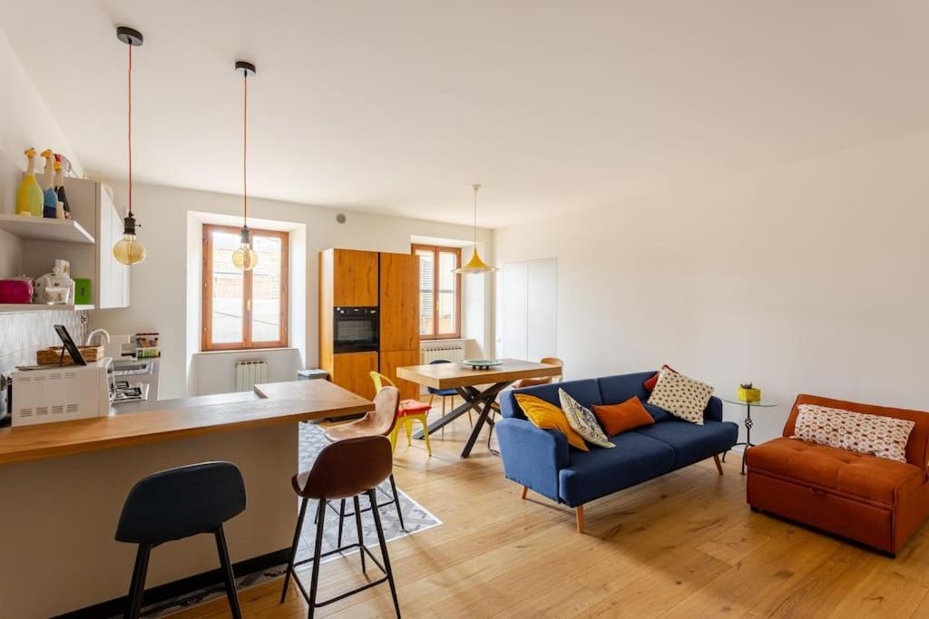 a kitchen and a living room with a blue couch at A Casa di Silvia in Recanati