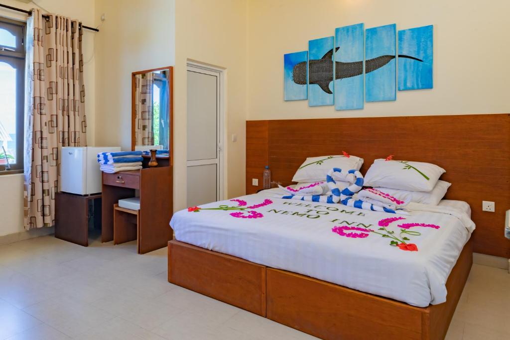 Postel nebo postele na pokoji v ubytování Nemo Inn