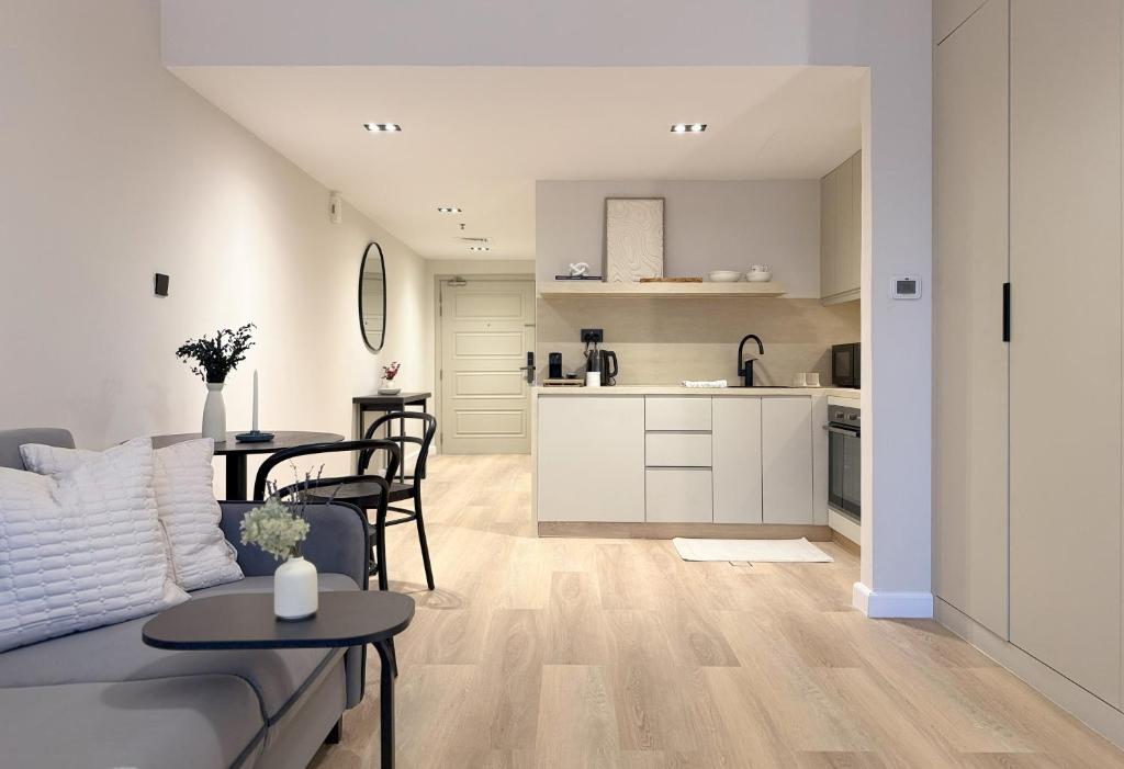 a living room and kitchen with a couch and a table at Signature Studio JLT in Dubai