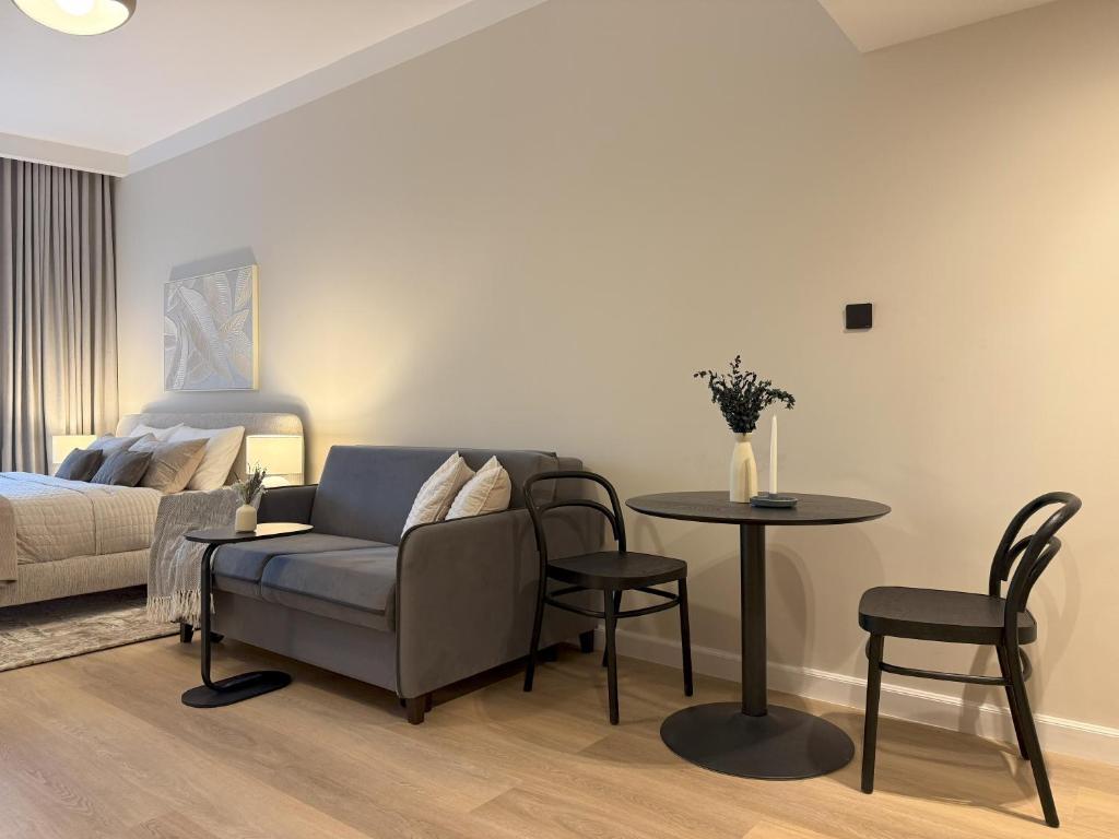 a living room with a couch and a table at Signature Studio JLT in Dubai
