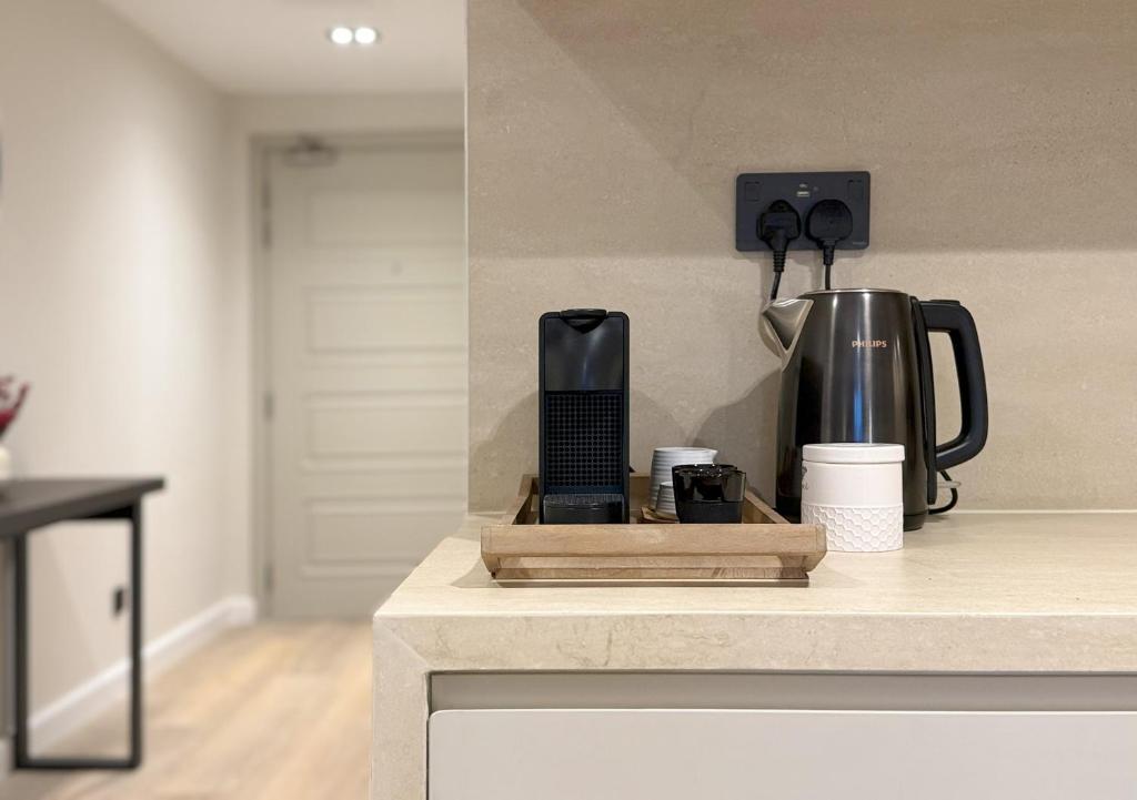 a kitchen counter with a coffee maker on a counter top at Signature Studio JLT in Dubai