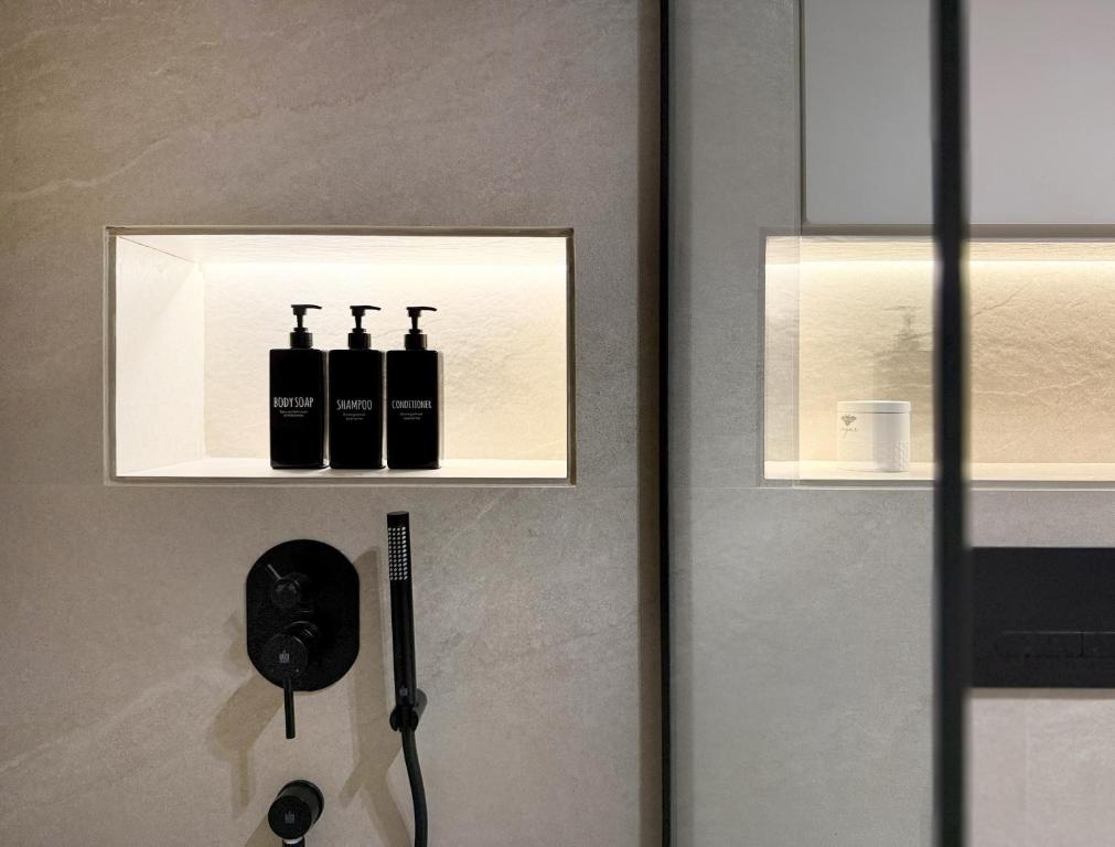 a door with two bottles of wine on a wall at Signature Studio JLT in Dubai