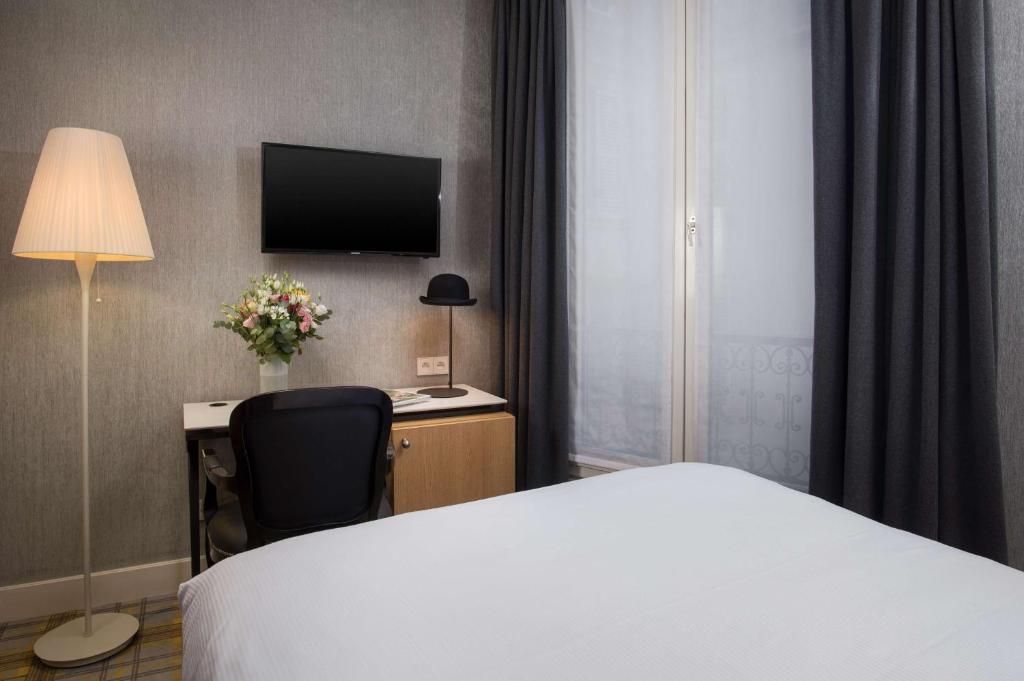 Postel nebo postele na pokoji v ubytování NH Paris Opéra Faubourg